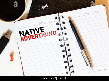 Text sign showing Native Advertising. Conceptual photo Online Paid Ads Match the Form Function of Webpage Scissors and writing equipments plus plain s Stock Photo