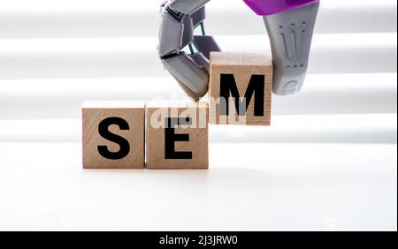 The Word SEM Formed By Wooden Blocks On A White Table. Stock Photo