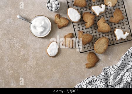 Easter background. Cookies in shape of easter bunny and easter eggs. Biege background top view space for text Stock Photo