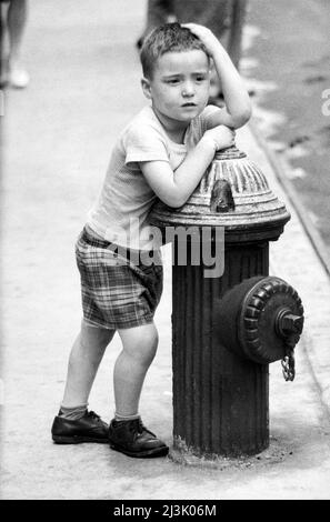 Young Boy leaning on Fire Hydrant, New York City, New York, USA, Angelo Rizzuto, Anthony Angel Collection, August 1960 Stock Photo