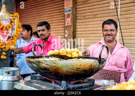 Men selling food at street market in India; Dehli, India Stock Photo