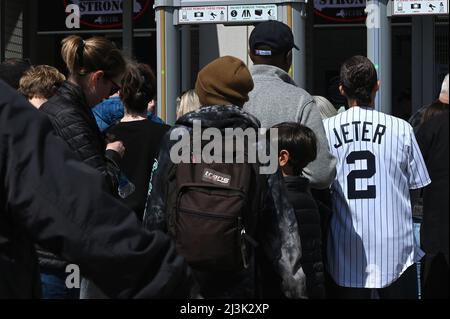 New York, USA. 08th Apr, 2022. A fan wearing a #2 Derek Jeter baseball jersey stands in line to attend Yankee opening day 2022, in the Bronx borough of New York City, NY, April 8, 2022. The Yankee's inaugural 2022 game was played against longtime rivals the Boston Red Sox. (Photo by Anthony Behar/Sipa USA) Credit: Sipa USA/Alamy Live News Stock Photo