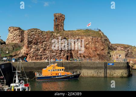 Dunbar Castle at Victoria harbour with boats mooring; Dunbar, East Lothian, Scotland Stock Photo