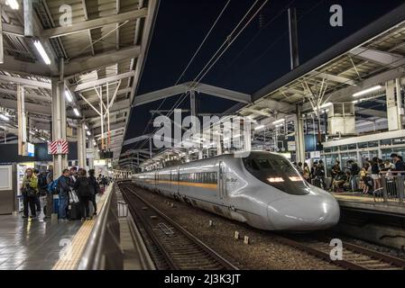 Japanese Shinkansen, or Bullet train pulling into the station in Okayama Japan.  The high speed trains connect most major Japanese cities and can oper Stock Photo