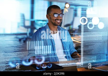 His new program is running smoothly. Shot of a happy computer programmer working on new software at his computer. Stock Photo