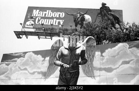 competing billboards for Marlboro Cigarettes and the movie Heaven Can Wait with Warren Beatty on the Sunset Strip in Los Angeles, CA, 1980. Stock Photo
