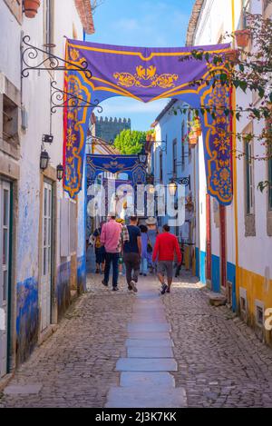 Obidos, Portugal, July 1, 2021: View of a narrow street inside of the obidos castle in Portugal. Stock Photo