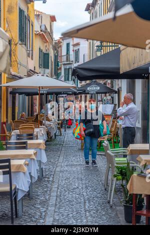Funchal, Portugal, June 13, 2021: Restaurants on a street in Portuguese town Funchal. Stock Photo