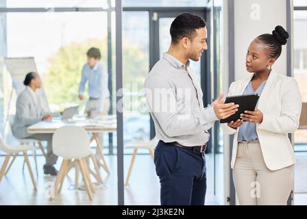 Our team project is on point. Shot of two professional coworkers using a digital tablet together at work. Stock Photo