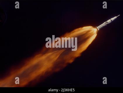 The five F-1 engines of the huge Apollo 7/Saturn V rocket leave a gigantic trail of flame in the sky above the Kennedy Space Center seconds after liftoff. October 11 1968 Stock Photo
