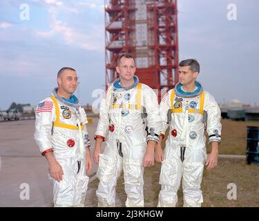 The crew of Apollo 1, from (left to right) Gus Grissom, Ed White, and Roger Chaffee, pose in front of Launch Complex 34 which is housing their Saturn 1 launch vehicle. The astronauts died ten days later in a fire on the launch pad. Stock Photo