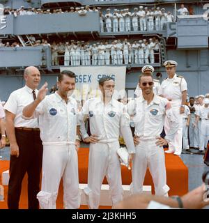 On 22 October 1968, the Apollo 7 crew aboard the U.S. Navy aircraft carrier USS Essex after splashdown.This was the first Apollo splashdown and, therefore, the first three person 'landing' for NASA. Left to right, are astronauts Walter Schirra, commander; Don Eisele, command module pilot; and, Walter Cunningham, lunar module pilot. In left background is Dr. Donald E. Stullken, NASA Recovery Team Leader from the Manned Spacecraft Center's Landing and Recovery Division. Stock Photo