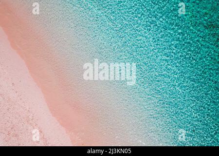 View taken directly above of a pink sand beach along the shore of Padar Island in Komodo National Park Stock Photo