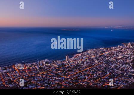Overview of Cape Town city skyline and shoreline along the Atlantic Ocean coast at dusk; Cape Town, Western Cape Province, South Africa Stock Photo