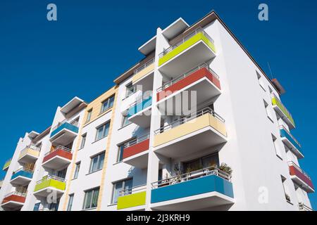 Refurbished social housing, refurbished prefabricated building with blue sky in background Stock Photo