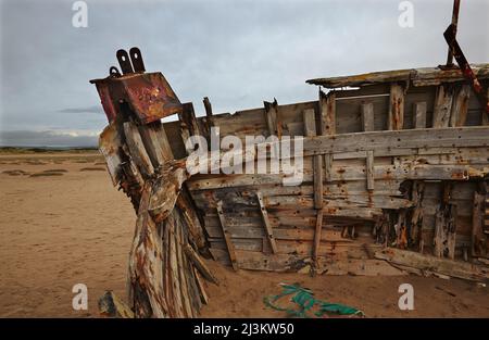 Weathered shipwreck lying in sand dunes at Crow Point, at the mouth of the Taw and Torridge Rivers, near Barnstaple, Devon, Great Britain Stock Photo