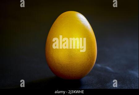 golden a easter egg on black background. Stock Photo