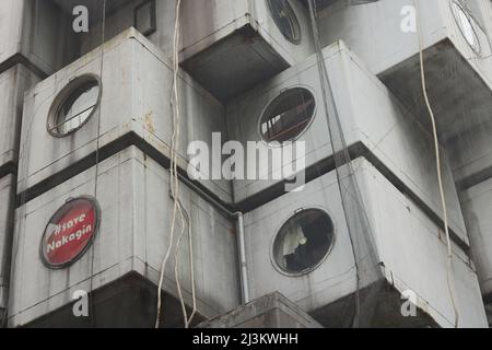 TOKYO, JAPAN -March 30, 2022:  Detail of Nakagin Capsule Tower in Tokyo. Sign in a window reads '#Save Nagakin'. Stock Photo