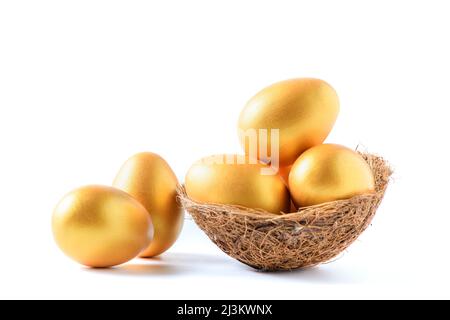 Golden a easter egg on nest bird isolated on white background. Stock Photo