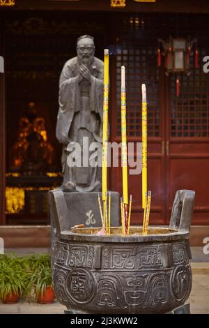 Incense sticks and a statue of Confucius in the Confucian Temple, Shanghai, China.; Nanshi, Old Town, Shanghai, China. Stock Photo