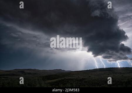 Lightning strikes from a passing supercell thunderstorm; Saskatchewan, Canada Stock Photo