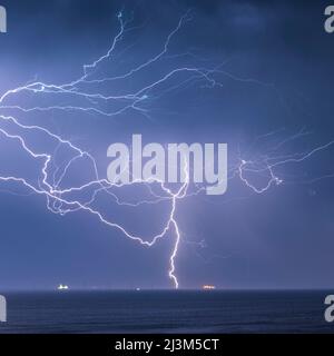A crazy bolt of lightning lights up the sky over the English Channel; Brighton, East Sussex, England