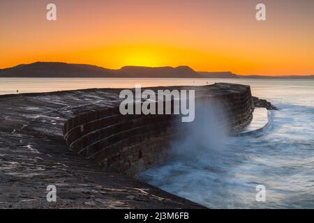 Lyme Regis, Dorset, UK.  9th April 2022.  UK Weather.  Clear skies during sunrise at the Cobb Harbour at Lyme Regis in Dorset on a cold frosty morning. Picture Credit: Graham Hunt/Alamy Live News Stock Photo