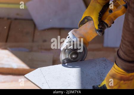 Closeup of worker use cutting machine cut a tile ceramic Stock Photo