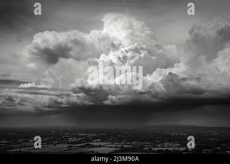 A line of towering cumulus clouds drifts across the English countryside; Brighton, East Sussex, England Stock Photo