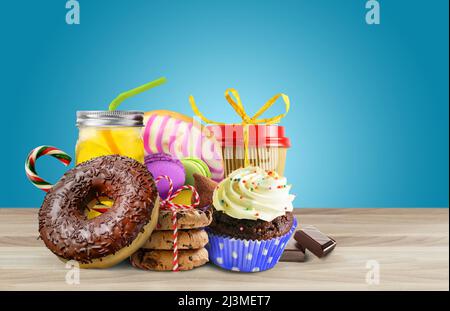 Various sweets on thr table on blue background Stock Photo