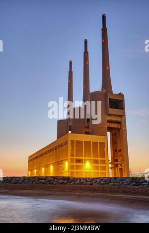 The decommissioned thermal power station at Sant Adria near Barcelona at twilight Stock Photo