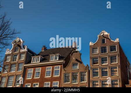 Amsterdam, Netherlands, April 2022. Historic facades along the canals of Amsterdam. High quality photo Stock Photo
