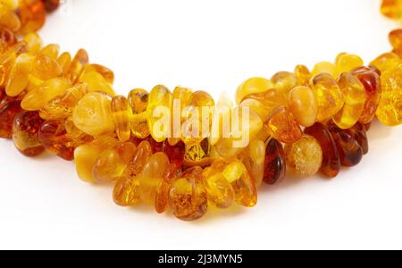 A necklace of pieces of brown amber, isolated on a white background Stock Photo
