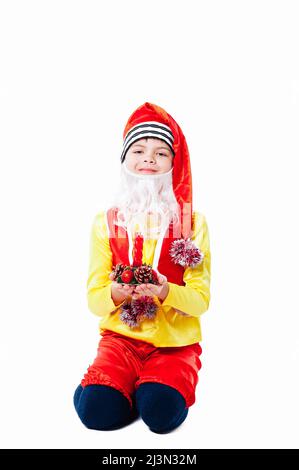 A baby dressed as a elf. isolated. Santa's helper. boy in suit of dwarf or elf Stock Photo