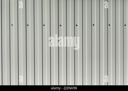 Texture of white fence. Steel fence. Background of vertical lines. Stock Photo
