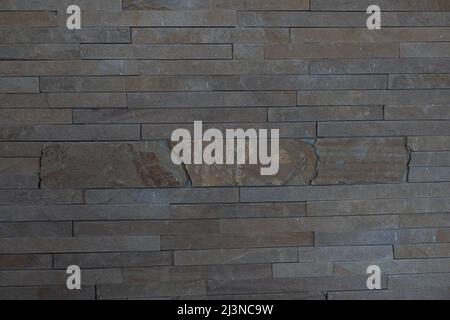 Elegant stone cladding wall made of gray granite with different shades Stock Photo