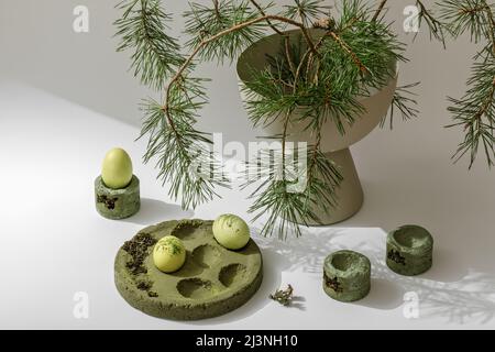 Zero waste Easter concept. Easter eggs coloured with matcha tea in moss green cement tray. Eco friendly lifestyle. Modern and contemporary interior de Stock Photo