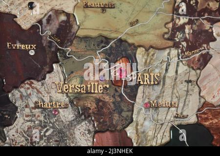 Paris and Versailles marked with precious stones and platinum rivers on the detail of the stone mosaic map of France produced by Russian craftsmen on display at the Château de Compiègne in Compiègne, France. The mosaic map was made from Ural precious and semiprecious stones by Russian craftsmen led by craftsman Danila Zverev and engineer Vasily Mostovenko at the Imperial Lapidary Factory in Yekaterinburg, Russian Empire. The map was exhibited at the Exposition Universelle in Paris in 1900 and was gifted to the French state during the visit of Tsar Nicholas II of Russia to the Château de Compi Stock Photo