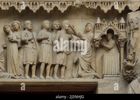 Decapitation of Saint Nicasius of Reims depicted in the tympanum of the central portal of the north facade of the Reims Cathedral (Cathédrale Notre-Dame de Reims) in Reims, France. Stock Photo