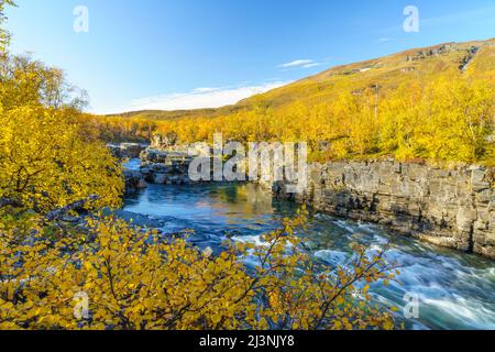 Abisko river in autumn season with autumn colors  and blue sky, Abisko national park, Swedish Lapland, Sweden Stock Photo