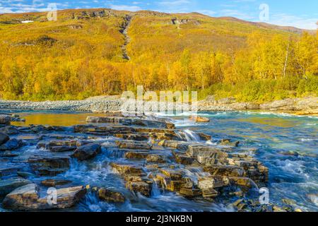 Abisko river in autumn season with autumn colors  and blue sky, Abisko national park, Swedish Lapland, Sweden Stock Photo