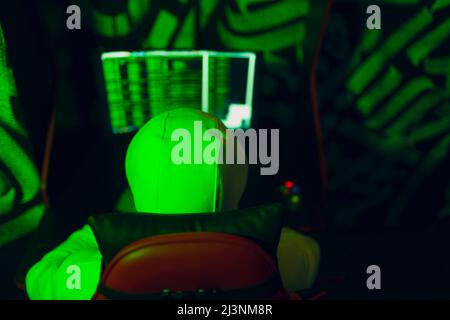 Hacker using computer malware software and hacking binary code green digital interface. Stock Photo