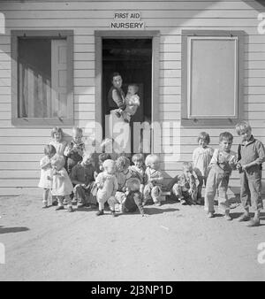 While the mothers are working in the fields, the preschool children of migrant families are cared for in nursery school under trained teachers. Kern migrant camp, California. Stock Photo