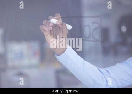 Are you here to witness the grandeur. Shot of an unrecognizable businessman having a brainstorming session on a glass screen in an office. Stock Photo