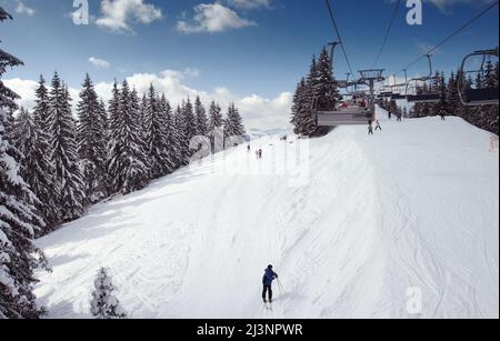 Ski lift chairs on bright winter day Stock Photo