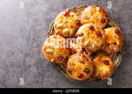 English Fat Rascals scones with dried fruits and almonds close-up in a plate on the table. Horizontal top view from above