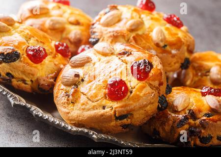 Delicious English scones Fat Rascals with dried fruits and almonds close-up in a plate on the table. horizontal