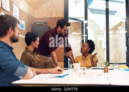 Taking steps to ensure success together. Shot of a diverse group of businesspeople having a meeting in an office. Stock Photo