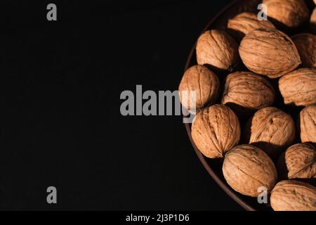 Walnuts on a dark background. Nutcracker close-up. Stock Photo