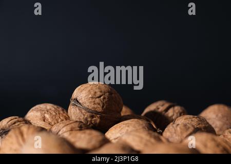 Walnuts on a dark background. Nutcracker close-up. Stock Photo
